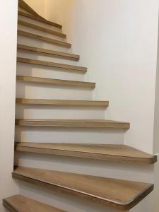 a stairwell with wooden steps in a house at Hotel Continental Amsterdam in Amsterdam