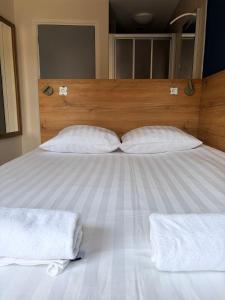 a large bed with two white towels on it at Hotel Continental Amsterdam in Amsterdam