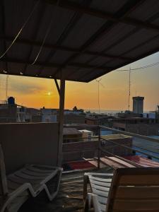 a view of the sunset from the roof of a building at El Duke Kahanamoku surf hostel in Pacasmayo