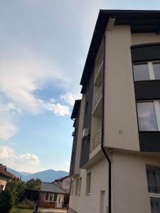 an apartment building with a view of the mountains at Vila Šarić in Doglodi