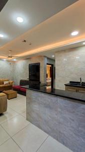a living room with a bar and a couch at Aqaba Roza in Aqaba