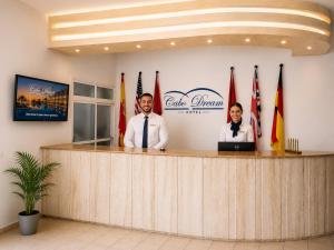 two people standing at a counter in a lobby at Appart Hôtel Cabo Dream in Cabo Negro