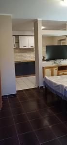 a room with a kitchen and a bed in it at Siedlisko na Skarpie in Garcz