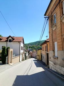 an empty street in a small town with houses at Travnik Memories Apartments in Travnik