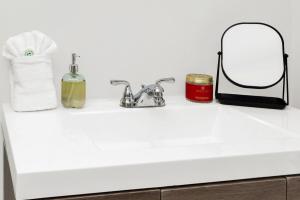a bathroom counter with a sink and a mirror at Cedar Street Retreat - Unit C in St. Augustine +16 photos