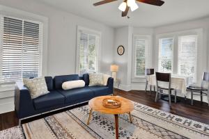 a living room with a blue couch and a table at Cedar Street Retreat - Unit C in St. Augustine