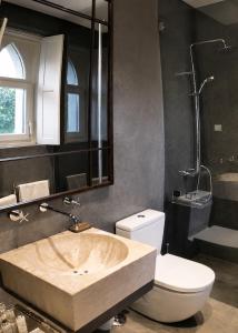 a bathroom with a sink and a toilet at A Capela - A Essência de Sintra in Sintra +33 photos