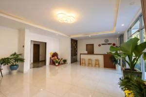 an empty lobby with plants in a building at Mimosa Forest Hotel Villa in Xuan An