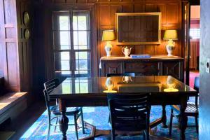 a dining room with a wooden table and chairs at The Sanctuary on Washington in Norwich