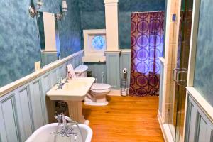 a bathroom with two sinks and a toilet and a shower at The Sanctuary on Washington in Norwich +44 photos