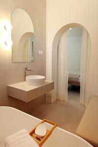a bathroom with a tub and a sink and a mirror at Casa Serena Bol in Bol +70 photos