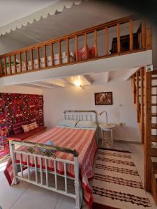 a bedroom with a bunk bed and a staircase at Asklipion Valley guest house in Kos