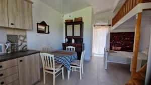 a kitchen with a table and chairs in a room at Asklipion Valley guest house in Kos +44 photos