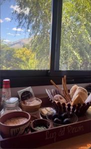 a table with a tray of food and a window at Luz del Rincón in Merlo