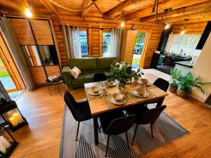 a living room with a table with chairs and a couch at Radawski Chill in Radawa