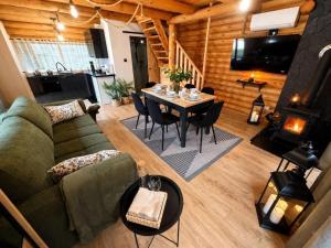 a living room with a green couch and a table at Radawski Chill in Radawa