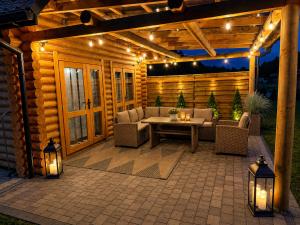 a patio with a table and chairs and lights at Radawski Chill in Radawa