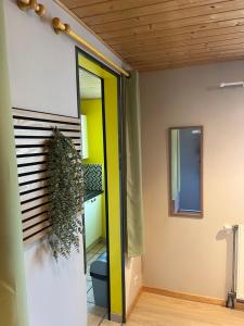 a room with a toilet and a door with a mirror at Le mignon in Pontcharra
