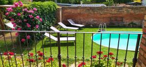 a garden with a pool and chairs and flowers at Starý dvůr pod Pálavou - Sýpka in Šakvice