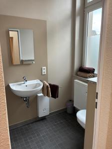 a bathroom with a sink and a toilet at Gästehaus Lelo 1 in Solingen
