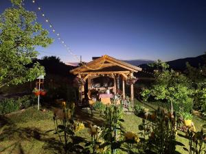 a gazebo in the middle of a garden at Rural accommodation Vidovic in Ugarci