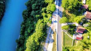 an aerial view of a road next to a river at KOPILOVE in Foča