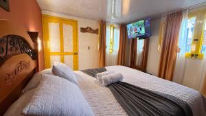 a bedroom with a large white bed with a television at Casa Salento in Salento