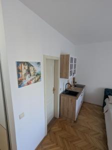 a small kitchen with a sink and a counter at Azzurro in Igalo