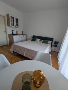 a bedroom with a bed and a table and chairs at Azzurro in Igalo