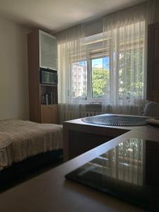 a bedroom with a bed and a large window at Acapulco Liepaja in Liepāja
