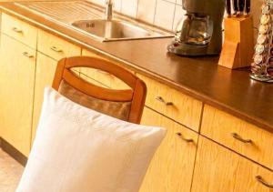 a wooden chair with a white pillow on a kitchen counter at Residenz Halberstädter Domschatz beliebt bei Monteuren Einzelbetten WlAN in Halberstadt +8 photos