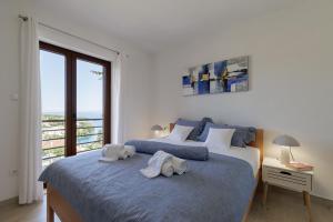 a bedroom with two beds with towels on them at Villa Užanca in Splitska
