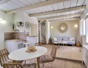 a living room with a table and chairs and a couch at La Bohème Mouriès in Mouriès