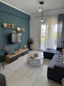 a living room with a couch and a table at VALANTIS APARTMENT in Kavála