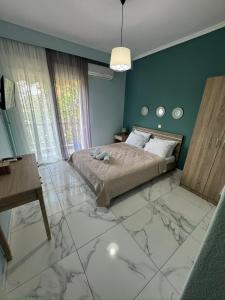 a bedroom with a bed with a marble floor at VALANTIS APARTMENT in Kavála