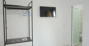 a glass shower door with a tv and a mirror at Hotel Bar Pizzeria Verona in Ksamil +29 photos