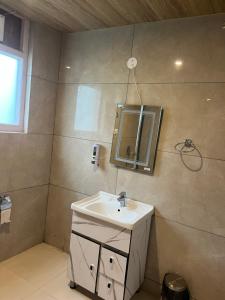 a bathroom with a sink and a mirror on the wall at MK Resort in Palchān +21 photos