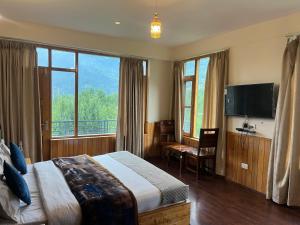 a hotel room with a bed and a large window at MK Resort in Palchān
