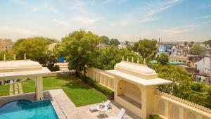 an aerial view of a building with a swimming pool at Pachewar Garh - A Heritage Fort in Pachhewar