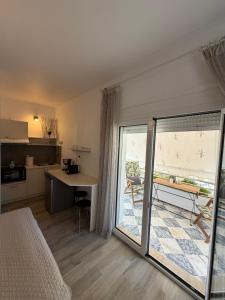 a room with a bed and a table and a kitchen at Elenas Apartments in Plataria