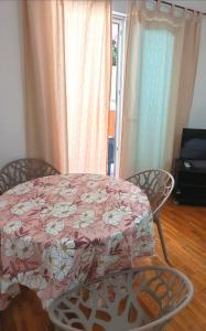 a table with a pink flowered table and two chairs at Riviera Budva Residence in Budva