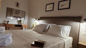 a bedroom with a large bed with white sheets and pillows at Abela Family Hotel in Argassi