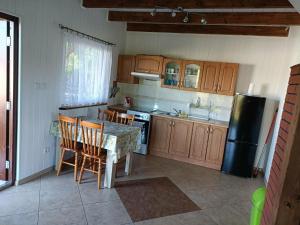 a kitchen with a table and chairs and a refrigerator at DOMEK SASINO in Sasino