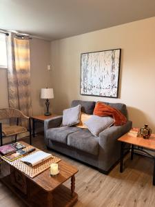 a living room with a couch and a table at Eastpoint Cozy Apartment in St. John's
