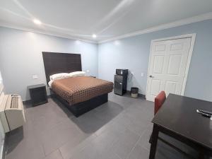 a bedroom with a bed and a white door at Coronado Motel in Long Beach