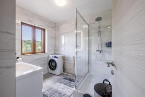 a white bathroom with a shower and a sink at Villa Užanca in Splitska +22 photos