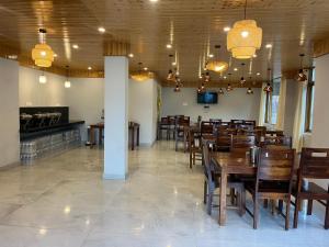 a dining room with wooden tables and chairs at MK Resort in Palchān