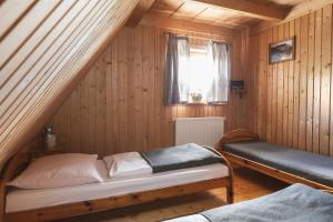 a small room with a bed and a window at Willa Rohacze in Kościelisko