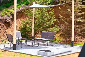 a gazebo with two chairs and a table at Tara mountain house Kopaonik in Kopaonik +66 photos