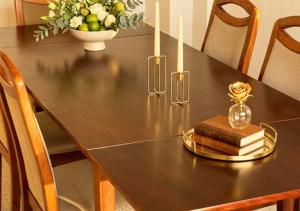 a dining room table with books and candles on it at Residenz Halberstädter Domschatz beliebt bei Monteuren Einzelbetten WlAN in Halberstadt